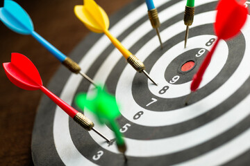 Many darts on the dartboard but not a single one hit on the center of the target, inaccurate arrow,...