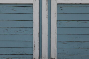 horizontal planks painted in a blue color, white plank vertically in the center, Symmetrical 