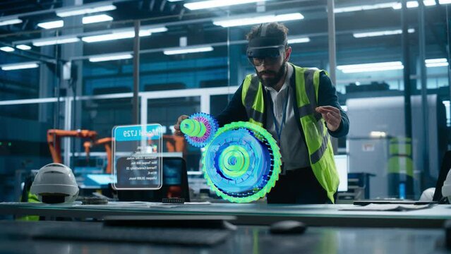 Male Engineer Uses an Augmented Reality Headset to Interact With 3D Holographic Model of Engine in a High-tech Factory, Showcasing Innovative Manufacturing Processes and Advanced Digital Visualization - Powered by Adobe