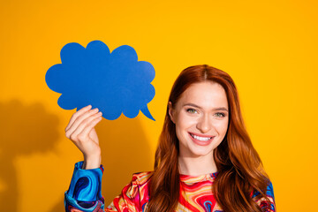 Photo portrait of lovely young lady hold paper speech bubble dressed stylish colorful garment isolated on orange color background