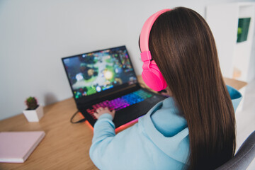 Photo of cute lovely nice girl little gamer sitting playing modern technology computer indoors house