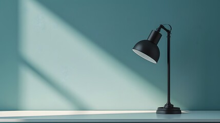A sophisticated, matte black desk lamp on a clean, white desk, against a soft, pastel blue wall. This photo embodies minimalist office design, with a focus on functionality and aesthetic appeal.