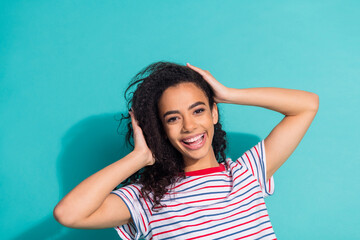 Fototapeta premium Photo portrait of lovely young lady touch soft hair enjoy dressed stylish striped garment isolated on cyan color background