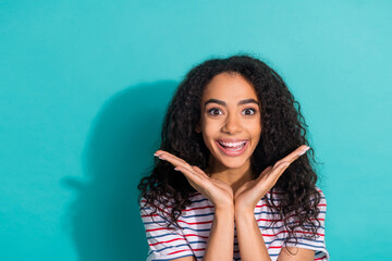 Fototapeta premium Photo portrait of attractive young woman raise hands amazed dressed stylish striped clothes isolated on aquamarine color background