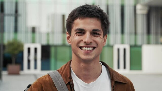 Portrait of young inspired man in the city - University student smiling to camera
