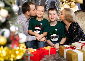 Family with mom and dad celebrates Christmas at home