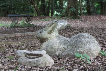 Stone sculpture of a parent and child rabbit in the park