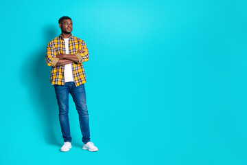 Photo of attractive handsome man wear trendy checkered clothes look empty space isolated on cyan...