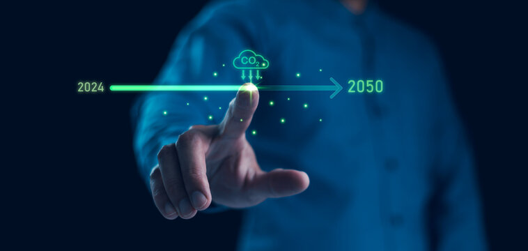 Businessman point to increasing arrow with carbon reduction for decrease CO2, Green house Global Economy concept. Carbon footprint and carbon credit to limit global warming from climate change.