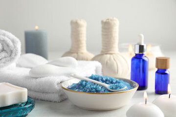 Spa composition. Cosmetic products, soap, towels, sea salt and burning candles on light table