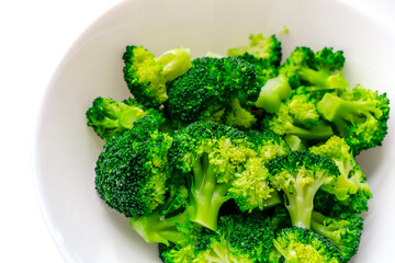 Broccoli on a large white plate. Love for broccoli.