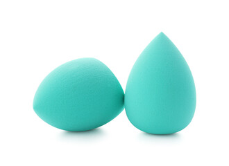 Two turquoise makeup sponges isolated on white