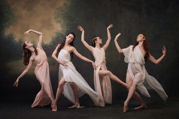 Classical Beauty. Dance ensemble in flowing robes captures essence of classical ballet against...
