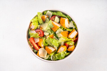 Fried Chicken Salad. Balanced salad with crispy chicken nuggets, fresh vegetables and cheese, copy space
