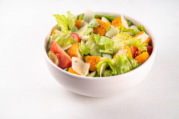 Fried Chicken Salad. Balanced salad with crispy chicken nuggets, fresh vegetables and cheese, copy space