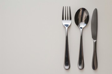 A set of utensils including knife, fork and spoon placed on a table