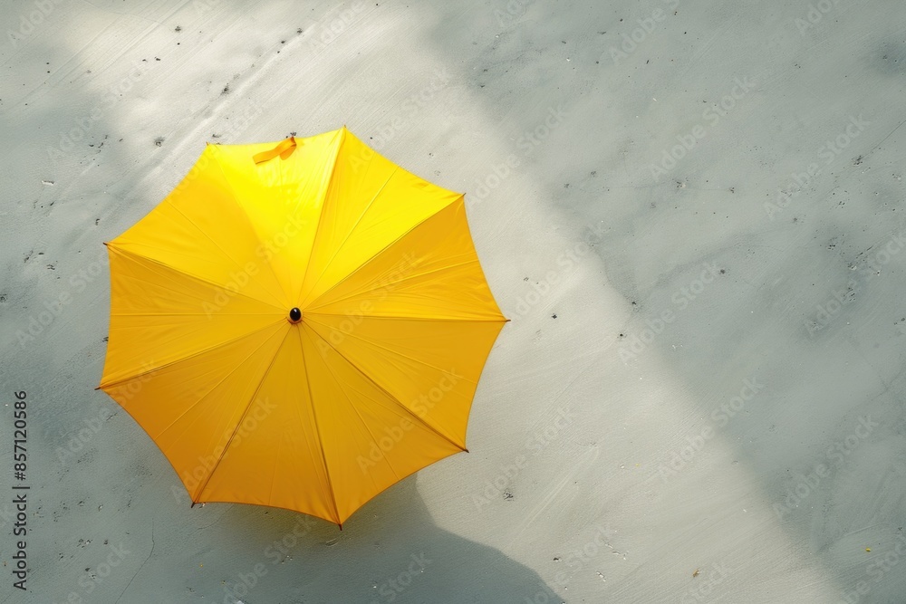 Poster a bright yellow umbrella sits alone on a white background, perfect for adding a pop of color to any 
