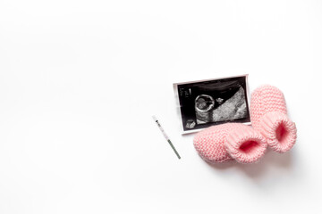Pregnancy test with Ultrasound image of a baby. Pregnancy and conceiving a child concept