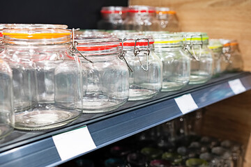 Neatly organized labeled food pantry in a home kitchen with spices grains flour rice sugar nuts