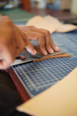 leather craftsmen work to make products