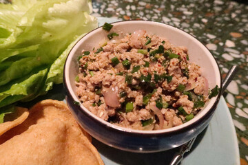 close up of Thai Asian food, Thai Minced Pork with Lettuce Wrap on a blue plate