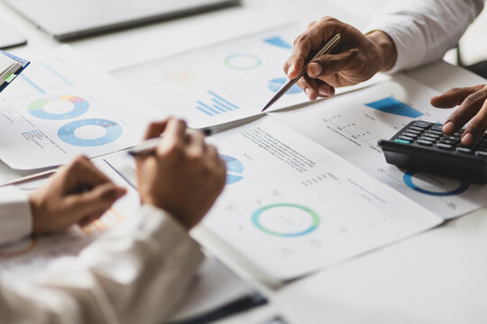 Business consulting meeting is discussing analysis financial data and business growth charts to plan strategy for generating company profits. Discuss cost budget analysis and plan to increase profits.
