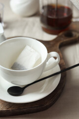 Tea bag in cup on light table, closeup