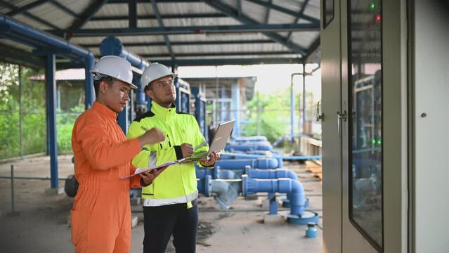 Electrical engineer man checking voltage at the Power Distribution Cabinet,preventive maintenance Yearly,Supervisor Working at a wastewater treatment plant