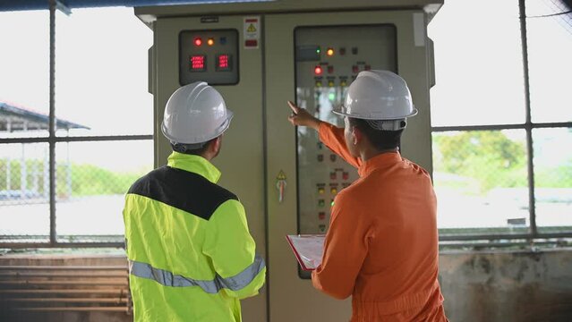 Electrical engineer man checking voltage at the Power Distribution Cabinet,preventive maintenance Yearly,Supervisor Working at a wastewater treatment plant