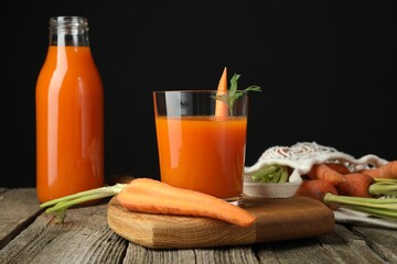 Healthy juice and fresh carrot on wooden table