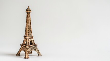 Small Eiffel Tower model against white backdrop