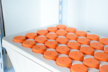 Close up of plant cloning tray with orange plastic circle or Hydroponic Cloner Aeroponic Tray for cultivation of plant seedlings or cannabis plants.