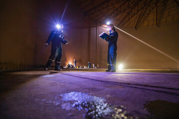 Male two worker inspection scan tank of rust thickness bottom plate area tank inside confined