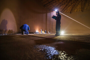 Male two worker inspection scan tank of rust thickness bottom plate area tank inside confined