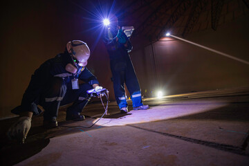 Male two worker inspection scan tank of rust thickness bottom plate area tank inside confined