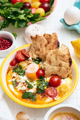 Cilbir or Turkish Eggs in white bowl. Turkish cuisine concept.