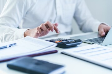 Fototapeta premium Business man Accountant investment risk analysis. saving money for Stock market trading with calculator. Accountancy Concept