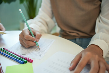 girl student reading book preparing for college exam Young female student studying and writing on notebook making  in school library.