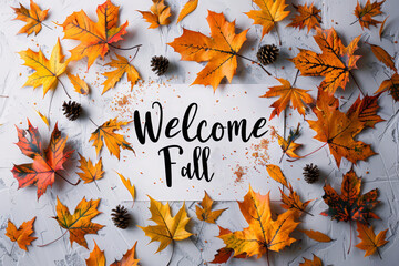 Welcome fall greeting card with colorful autumn leaves and pinecones on white background.