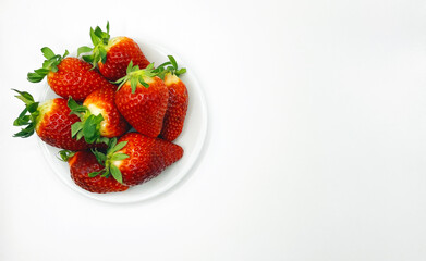 Juicy delicious strawberries in a plate. Lots of strawberries. Strawberries in a container. Red strawberries.