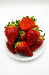Juicy delicious strawberries in a plate. Lots of strawberries. Strawberries in a container. Red strawberries.