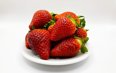 Juicy delicious strawberries in a plate. Lots of strawberries. Strawberries in a container. Red strawberries.