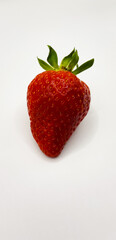 Bright juicy red strawberries. Beautiful strawberries on a white background. One strawberry macro
