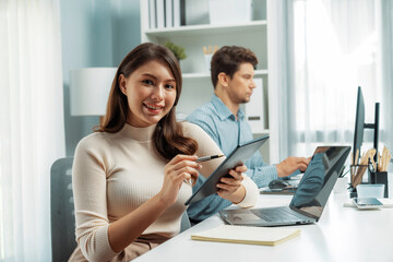 Smiling beautiful woman holding tablet to recheck list, looking at camera photo shooting portrait...