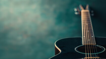 Fototapeta premium Closeup of a black acoustic guitar on a light green background