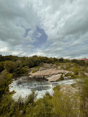 Traveling along the mountain cliffs of a large canyon by boat in the middle of the lake. The beauty and tranquility of wild forests and green plants far from the city. Peace and relaxation