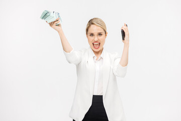 Obraz premium Successful business woman rejoices and enjoys a large sum of money on a white studio background. Concept of successful business, credit and financial services.