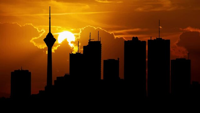 Tehran City Skyline, the Capital of Iran, Time Lapse at Sunset with Red Sun and Fiery Sky
