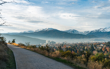 Road in the mountain with a view of the capital after the rain with the mountains as background and a light fog in autumn.
Perfect photo of Los Andes in Las Condes,  Santiago, Chile