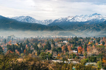 Autumn after rainin the capital with the mountains as background and a light fog.
Perfect photo of Los Andes in Las Condes,  Santiago, Chile